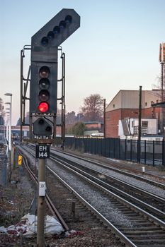 Hampshire, UK - February 11, 2012:  A single red light showing danger ahead to a train driver on a UK railway track in Hampshire, UK on a winter afternoon.