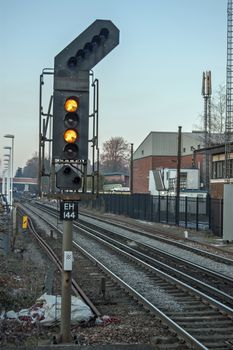 Hampshire, UK - February 11, 2012:  Two yellow lights on a railway signal showing preliminary caution to the driver of a train and suggesting that the next signal will have a single yellow caution light.  Winter afternoon in Hampshire, UK.