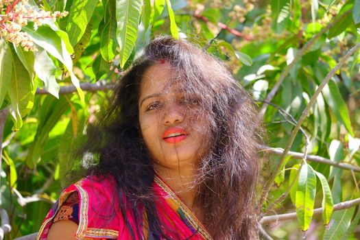 A beautiful girl in the garden with scattered hair