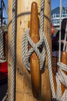 Close up of marine wires, cables attached to the wooden wings column forming a marine secure node