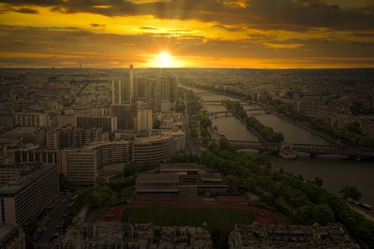 Sunset view from the Eiffel tower on Paris city, Champs de Mars, Trocadéro and skyline toward La Défense business district, France