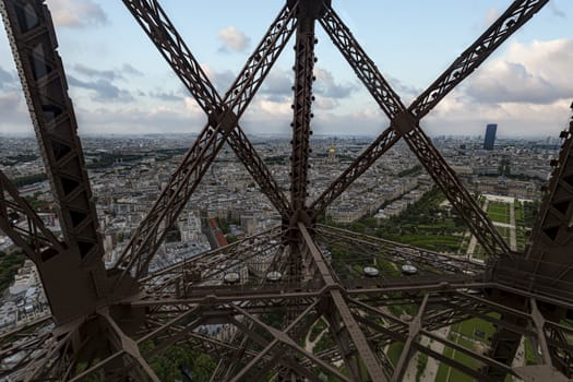 Paris panorama view front Eiffel tower lift throughout the steel bars screwed to each others, France