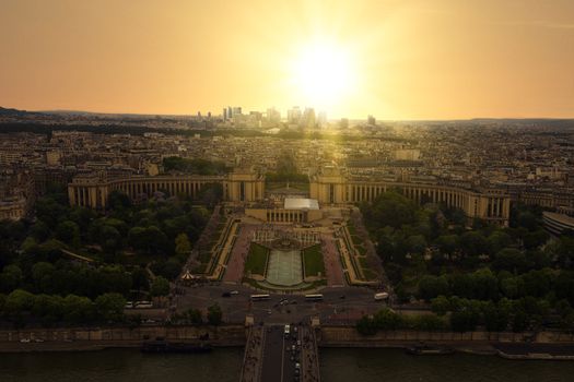Sunset view from the Eiffel tower on Paris city, Champs de Mars, Trocadéro and skyline toward La Défense business district, France