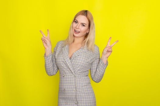 Attractive blonde woman in plaid jacket dress