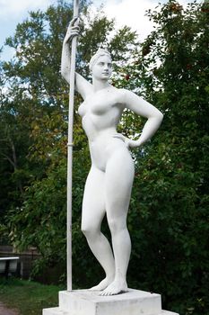 Classical Soviet art. Girl with a paddle statue in garden