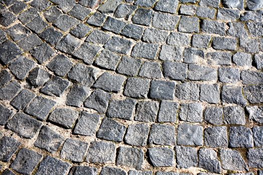 Old Pavement Background. Old empty cobblestone roadway in provincial town
