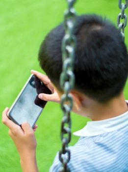 Serious boy playing on smartphone, Children playing game on smartphone