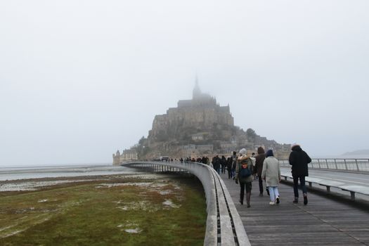 Panoramic views of Mont Saint Michel in a foggy morning. Stratified fog and suggestive view of the place