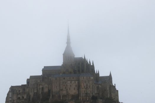 Panoramic views of Mont Saint Michel in a foggy morning. Stratified fog and suggestive view of the place