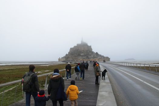 Panoramic views of Mont Saint Michel in a foggy morning. Stratified fog and suggestive view of the place