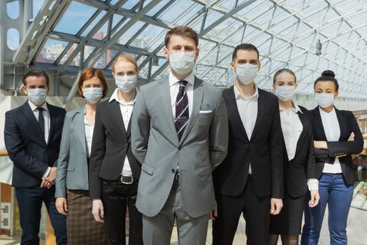 Business people wearing surgical protective masks and standing together, healthcare and covid-19 prevention concept