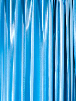 Bright and shiny blue color of curtain in the room