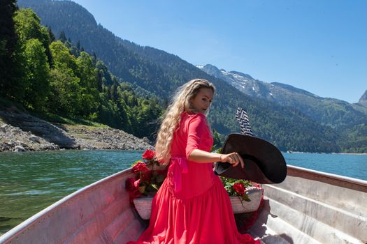 woman with long blond hair on boat with roses and flowers on blue