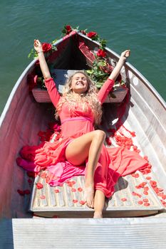 romantic scene with female model with long blond hair on a boat. Life style Shooting of a girl