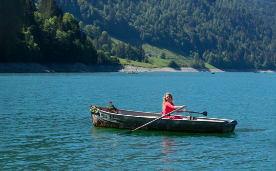 romantic scene with female model with long blond hair on a boat. Life style Shooting of a girl