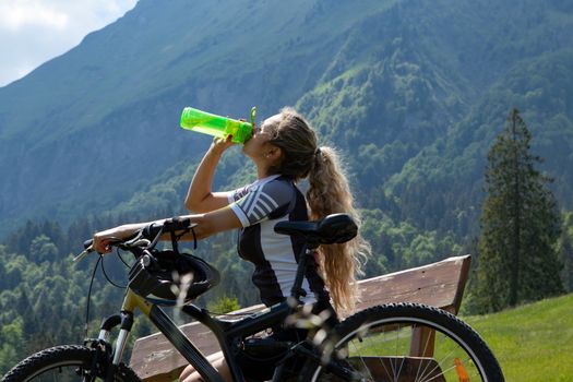 Life style woman with long blond hair on mountain bike in Swiss