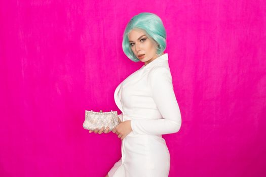 Beautiful young woman with menthol short hair in a white business jacket dress holding a silver small handbag