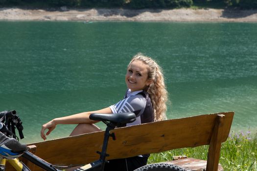 Life style woman with long blond hair on mountain bike in Swiss Alps