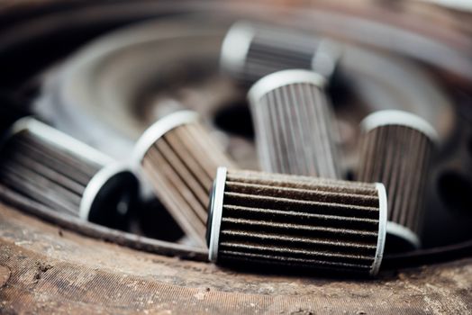 Old lubricant engine oil filter at car garage after changing the new oil filter for repair or maintenance in a car engine