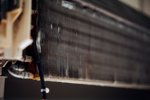 Worker to cleaning coil cooler of air conditioner by water for clean a dust on the wall in customer home when maintenance service