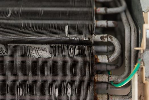 Worker to cleaning coil cooler of air conditioner by water for clean a dust on the wall in customer home when maintenance service