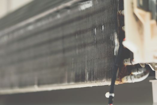 Worker to cleaning coil cooler of air conditioner by water for clean a dust on the wall in customer home when maintenance service