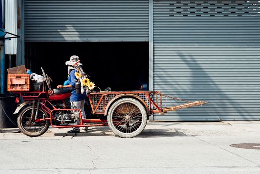 Asian man buying antiques or unused items freight by Freight Tricycles (Saleng, Zaleng) for recycle to sell