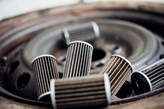 Old lubricant engine oil filter at car garage after changing the new oil filter for repair or maintenance in a car engine