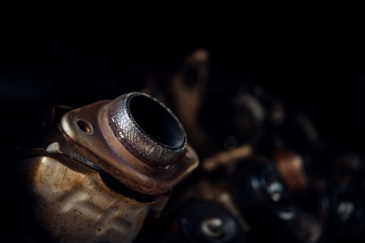 Disassembled car dirty engine close-up to engine parts and catalytic flange of muffler at car garage