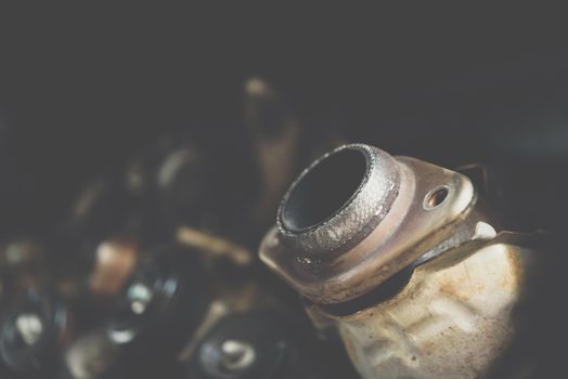 Disassembled car dirty engine close-up to engine parts and catalytic flange of muffler at car garage