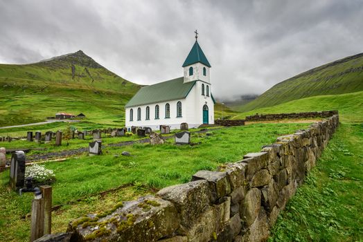 Small village church with cemetery in Gjogv located on the northeast tip of the island of Eysturoy, Faroe Islands, Denmark