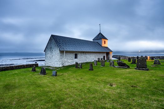 Small church with cemetery in the village of Kirkjubour, Faroe Islands, Denmark