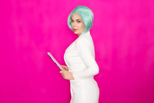 Beautiful young woman with short blue hair in a white business dress jacket holding a black folder with documents