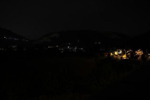 night landscape with street lights and mountains
