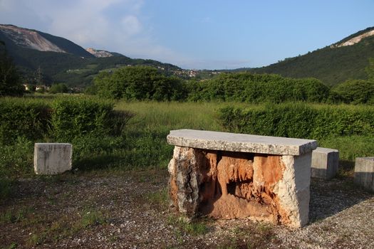 small stone altar in a meadow in Italy