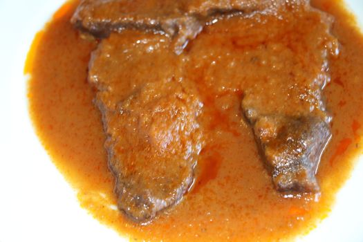 braised meat slices in the dish with sauce