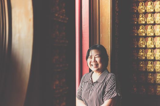 Asian woman 40s white skin plump body at Wat Boromracha Kanchanapisek Anusorn (Leng Noei Yi 2) is a Chinese temple under the patronage of the Chinese Buddhist Sangha in Thailand or Mahayana Buddhism.