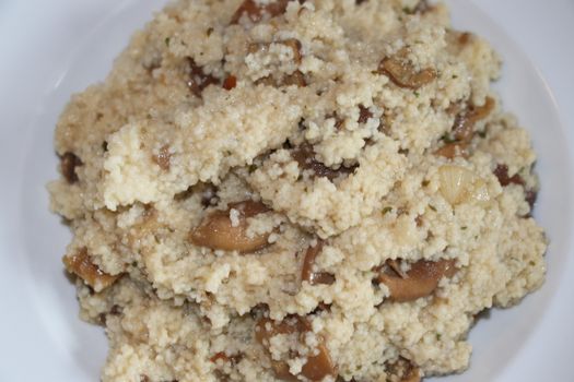 Dish with mushroom and couscous in a plate