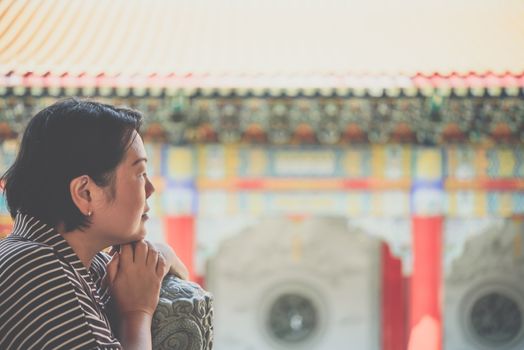 Asian woman 40s white skin plump body at Wat Boromracha Kanchanapisek Anusorn (Leng Noei Yi 2) is a Chinese temple under the patronage of the Chinese Buddhist Sangha in Thailand or Mahayana Buddhism.