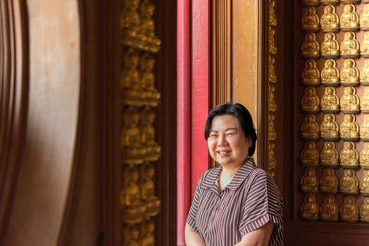 Asian woman 40s white skin plump body at Wat Boromracha Kanchanapisek Anusorn (Leng Noei Yi 2) is a Chinese temple under the patronage of the Chinese Buddhist Sangha in Thailand or Mahayana Buddhism.