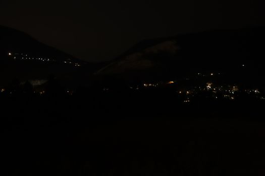 night landscape with street lights and mountains