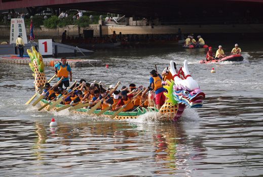 KAOHSIUNG, TAIWAN - JUNE 23: An unidentified team competes in the 2012 Dragon Boat Races on the Love River on June 23, 2012 in Kaohsiung
