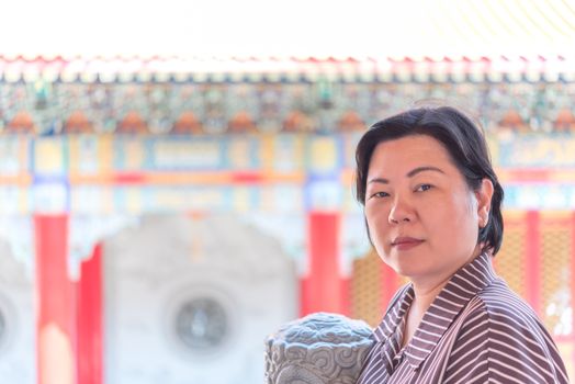 Asian woman 40s white skin plump body at Wat Boromracha Kanchanapisek Anusorn (Leng Noei Yi 2) is a Chinese temple under the patronage of the Chinese Buddhist Sangha in Thailand or Mahayana Buddhism.