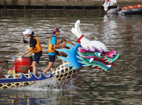 KAOHSIUNG, TAIWAN - JUNE 23: An unidentified team competes in the 2012 Dragon Boat Races on the Love River on June 23, 2012 in Kaohsiung