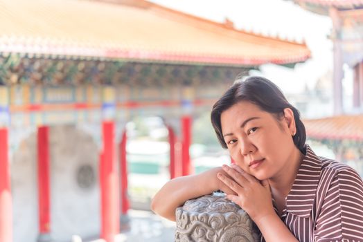 Asian woman 40s white skin plump body at Wat Boromracha Kanchanapisek Anusorn (Leng Noei Yi 2) is a Chinese temple under the patronage of the Chinese Buddhist Sangha in Thailand or Mahayana Buddhism.