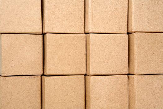 Stack of cardboard cubes closeup as background