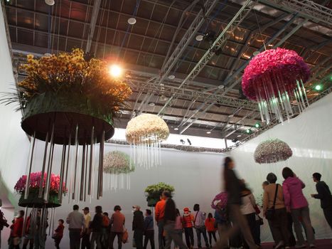 TAINAN, TAIWAN - MARCH 14: Visitors enjoy an artistic flower design at  the 2013 Taiwan International Orchid Show on March 14, 2013 in Tainan.