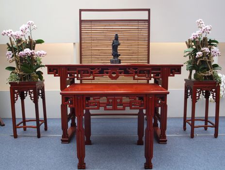 TAINAN, TAIWAN - MARCH 14: An exhibit that combines Chinese traditional furniture and orchids at the exhibition at the 2013 Taiwan International Orchid Show on March 14, 2013 in Tainan.