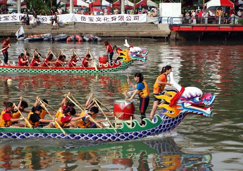 KAOHSIUNG, TAIWAN - JUNE 23: Two unidentified teams compete in the 2012 Dragon Boat Races on the Love River on June 23, 2012 in Kaohsiung
