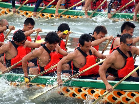 KAOHSIUNG, TAIWAN - JUNE 23: Two unidentified male teams compete in the 2012 Dragon Boat Races on the Love River on June 23, 2012 in Kaohsiung
